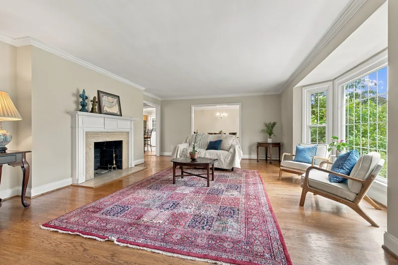 Living room with a fireplace and a bay window